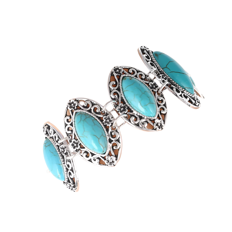 Turquoise stone bracelet with silver filigree on a mannequin arm