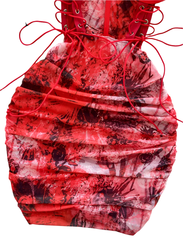 Red and black patterned dress with lace-up back on a textured surface