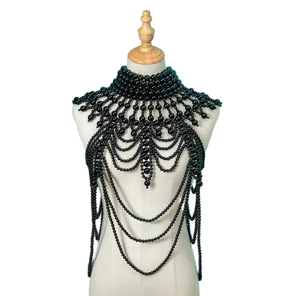 Black beaded necklace on a mannequin against a teal background