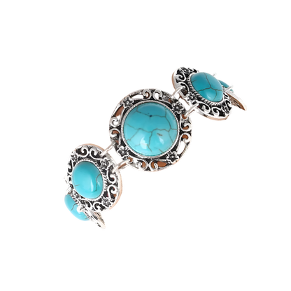 Turquoise stone bracelet on a wrist against a white background
