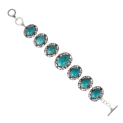 Turquoise stone bracelet with silver accents on a white background