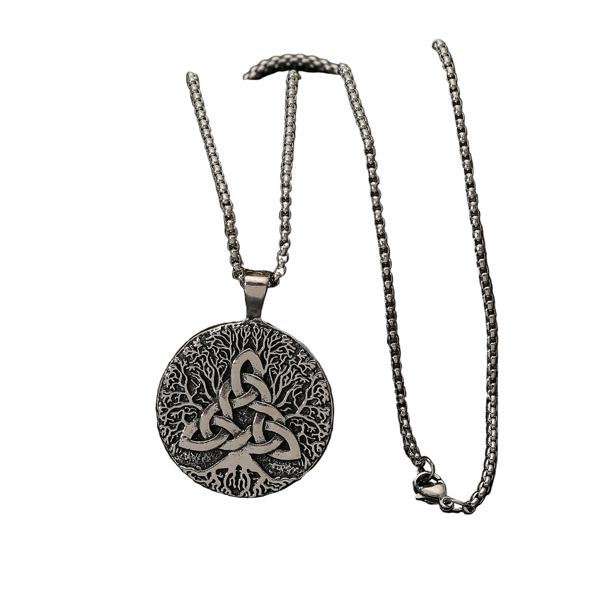 A silver Celtic knotwork pendant necklace displayed on a dark rock against a black reflective surface.