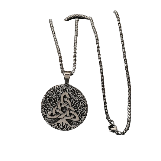 A silver Celtic knotwork pendant necklace displayed on a dark rock against a black reflective surface.