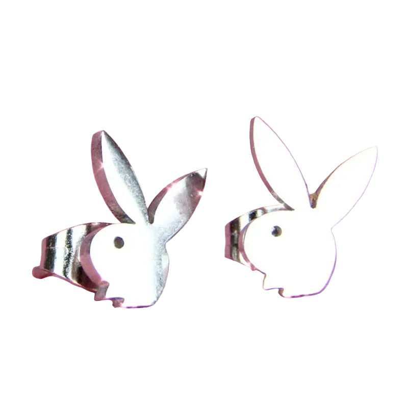 A pair of silver bunny-shaped stud earrings on a textured pink background.