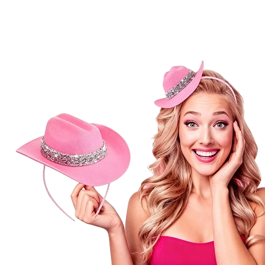A smiling blonde woman wearing a small pink cowboy-style hat with a silver rhinestone band, while holding the same hat in her hand against a plain white background.