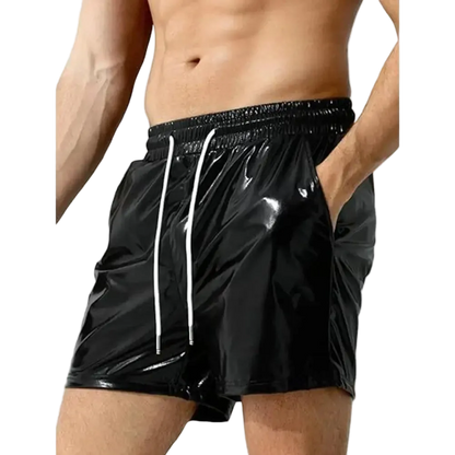 Black shiny vinyl swim trunks with white drawstrings, shown on a male model against a white background.