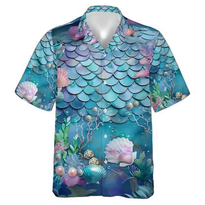 A short-sleeve button-up camp shirt featuring an all-over mermaid scale and underwater print in shades of teal, blue, purple, and pink, with seashells, pearls, and sea plants.