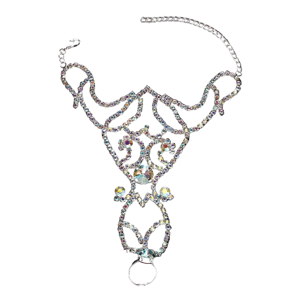 A silver-toned belly ring adorned with intricate rhinestone filigree and a large iridescent center crystal, displayed on a dark reflective surface.