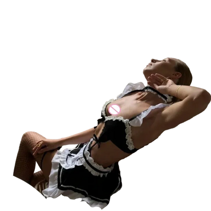 A woman reclining in a wicker chair indoors, wearing a black and white frilly maid-style lingerie outfit with fishnet stockings. A window behind her shows greenery outside, and her chest is partially obscured by a circular privacy block.
