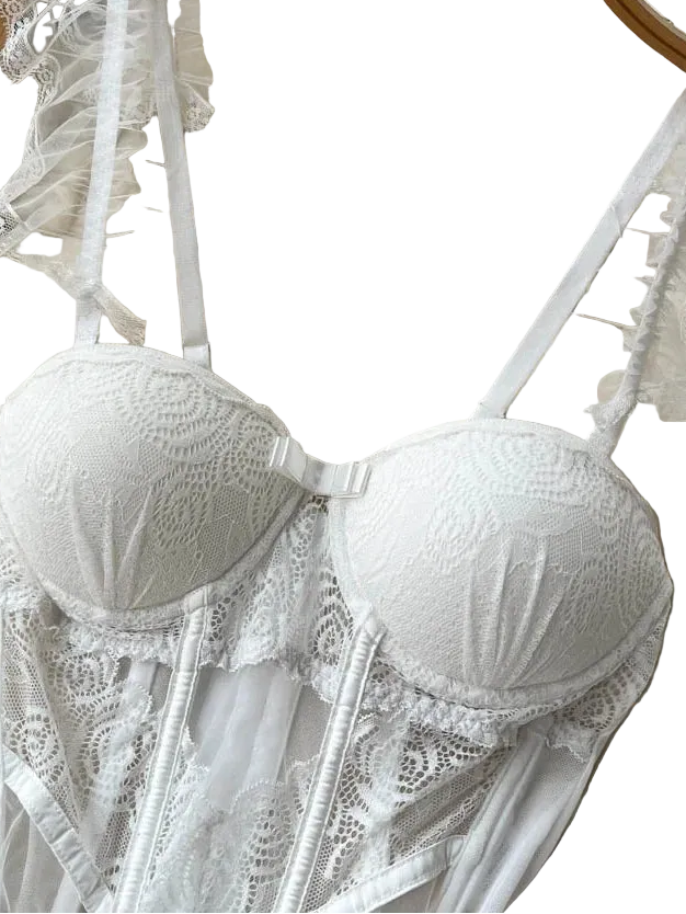 White lace bra on a hanger with a textured background