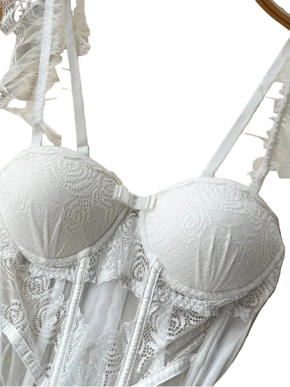 White lace bra on a hanger with a textured background
