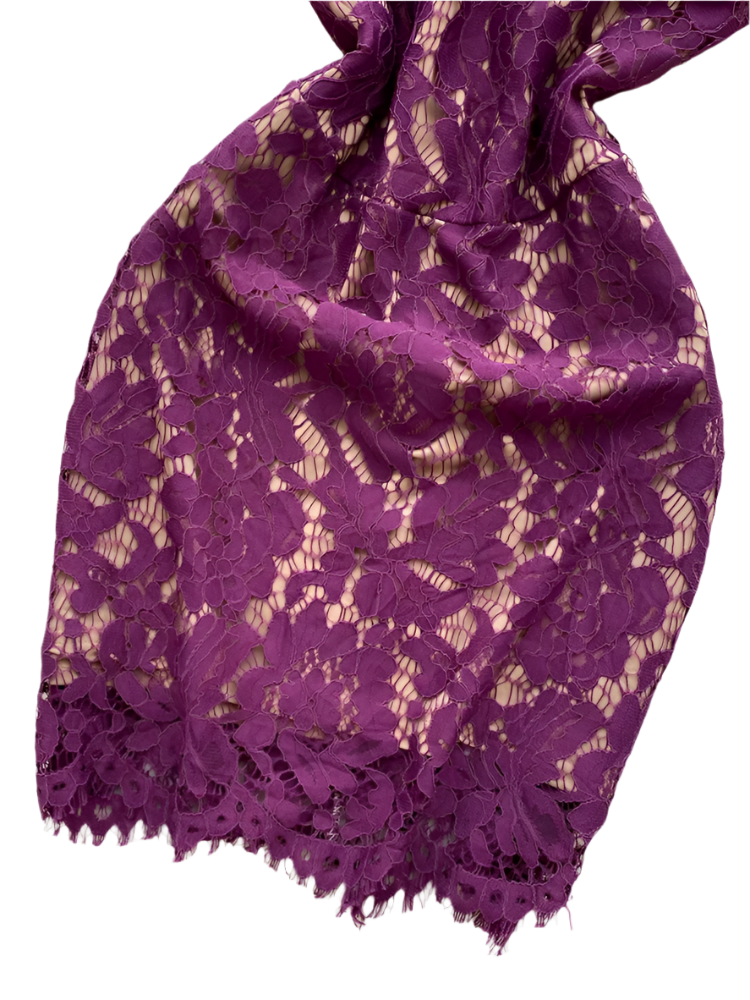 Purple lace fabric on a white fluffy surface 