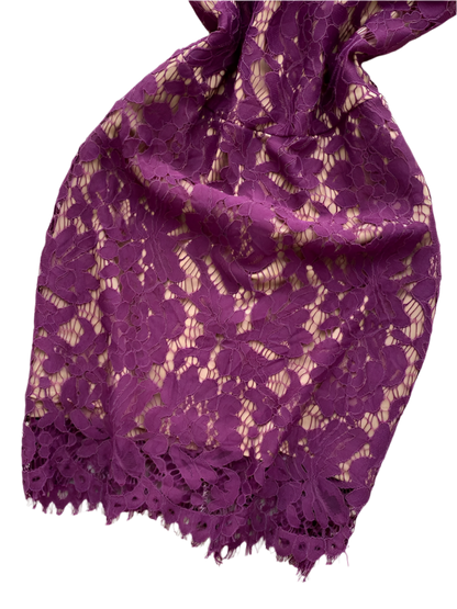 Purple lace fabric on a white fluffy surface 