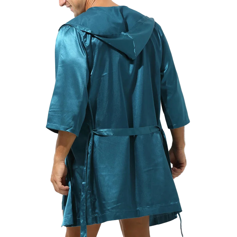Teal raincoat worn by a person on a white background
