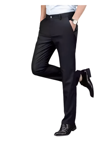 Person wearing black dress pants with a gray background