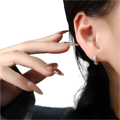 Sterling silver snake hoop earrings with smooth surface design and zircon accents for elegant resort wear

