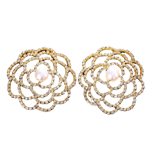 Pair of gold and pearl earrings on a white background