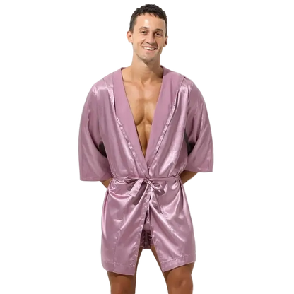 Man wearing a pink satin robe on a white background