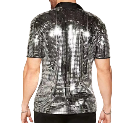 Person wearing a silver sequin shirt on a plain background