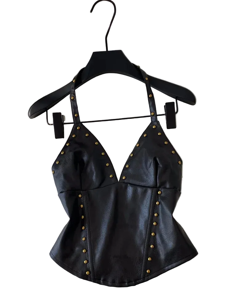 Black faux leather halter top with gold-tone studs, hanging on a black hanger against a white background.