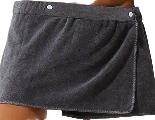 Gray towel skirt draped over a person's waist against a neutral background
