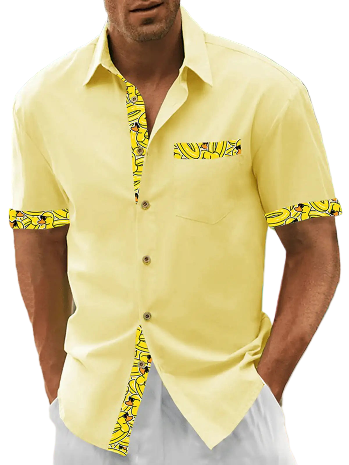 Man wearing a yellow shirt with patterned sleeves on a beach