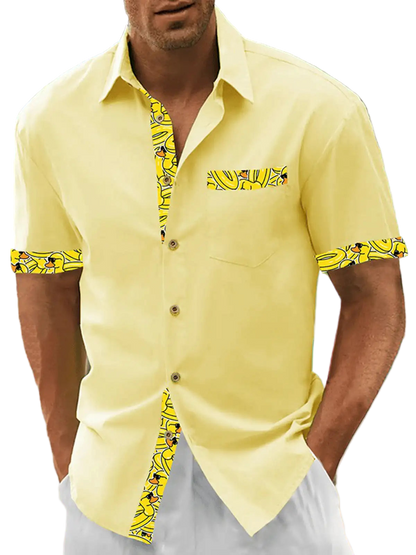 Man wearing a yellow shirt with patterned sleeves on a beach