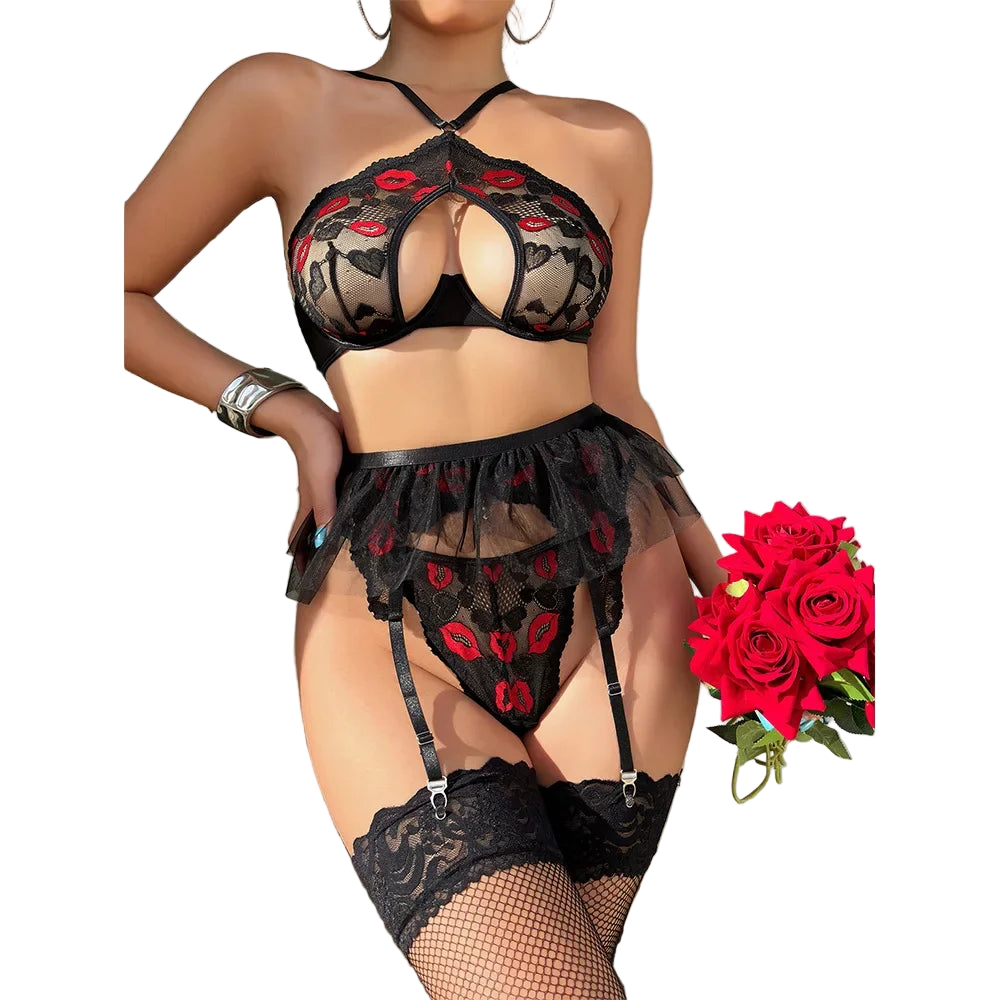 Person wearing black lace lingerie with red floral details, standing next to a bouquet of red roses.
