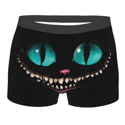 boxer shorts featuring the Cheshire Cat design from Alice in Wonderland, with glowing turquoise eyes and distinctive grinning teeth illuminated against a dark background.