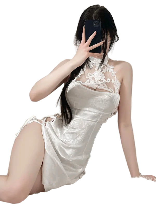 Person wearing a white lace dress with a high slit, taking a mirror selfie.