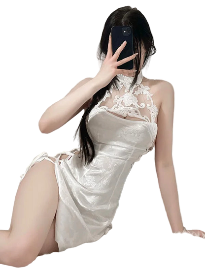 Person wearing a white lace dress with a high slit, taking a mirror selfie.