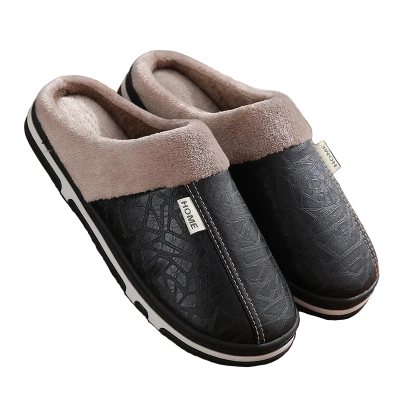 Pair of black slippers with brown fuzzy lining on a wooden floor.