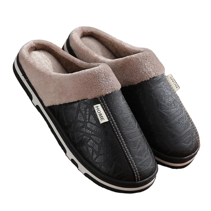 Pair of black slippers with brown fuzzy lining on a wooden floor.
