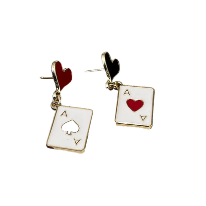 Pair of card-themed earrings on a wooden surface