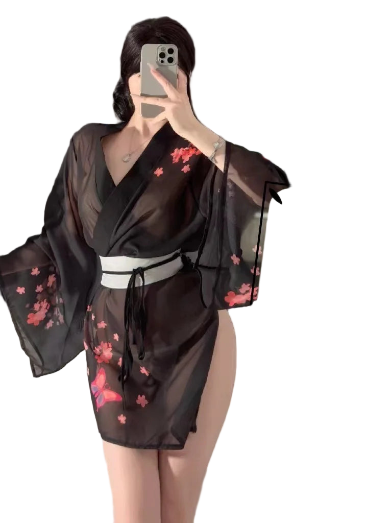 Person wearing a black kimono with pink floral patterns in front of a mirror.