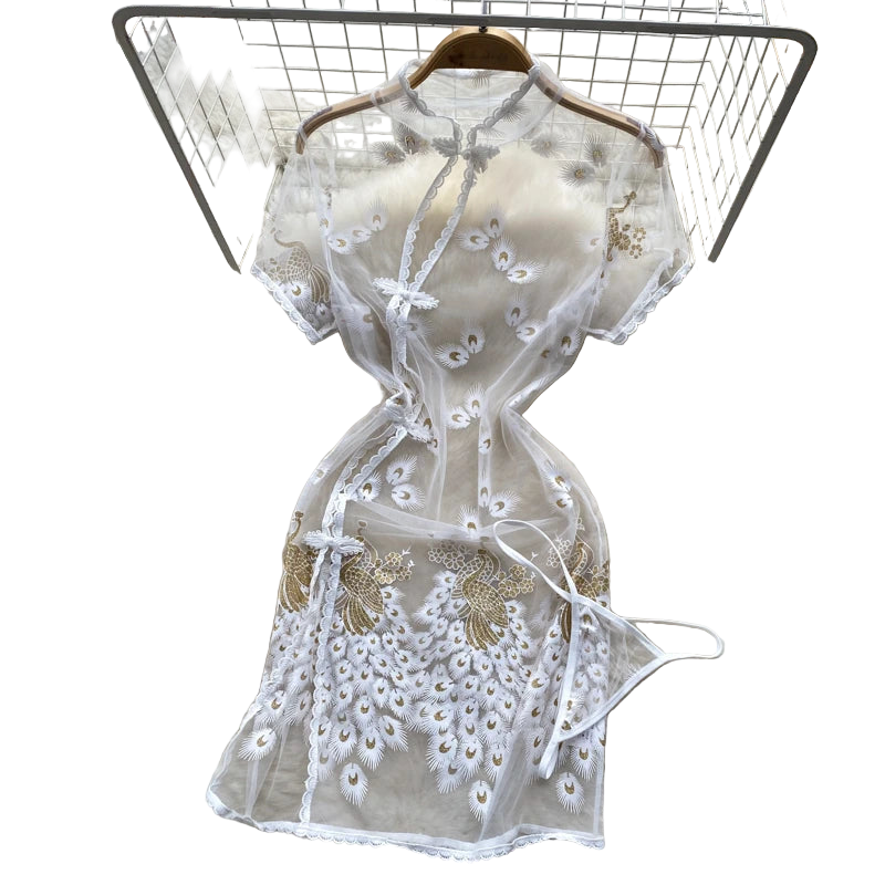 White lace dress on a fur rug with flowers and a hat in the background