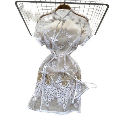 White lace dress on a fur rug with flowers and a hat in the background