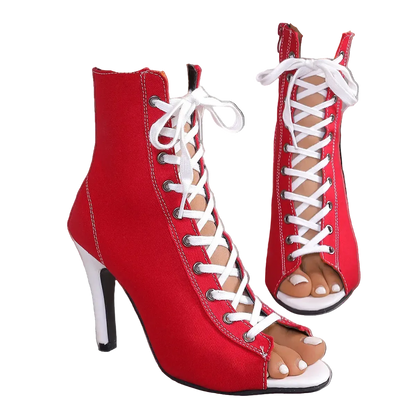 Red high-heeled lace-up shoes with white laces on a neutral background