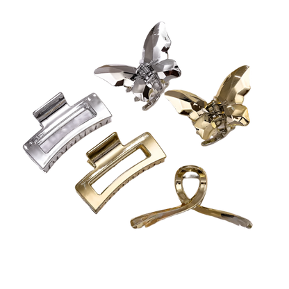 Set of gold and silver hair clips on a white background