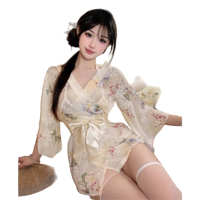 Woman in a floral kimono sitting on a couch with flowers and a fan in the background