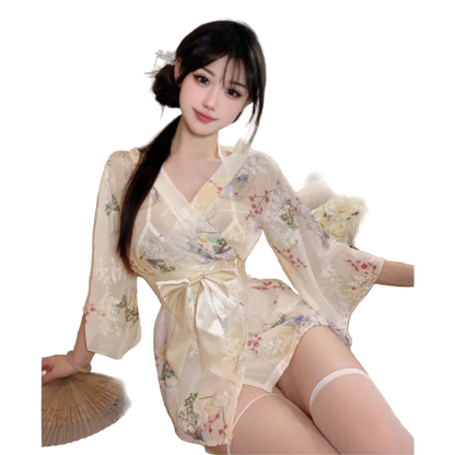 Woman in a floral kimono sitting on a couch with flowers and a fan in the background