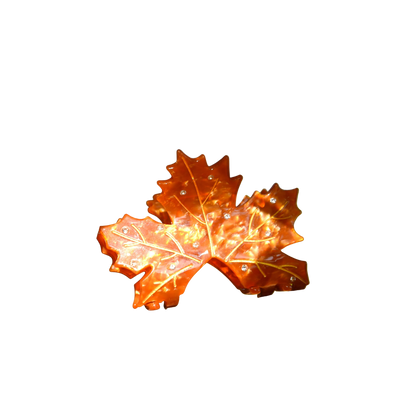Decorative orange leaf on a branch with a blurred natural background