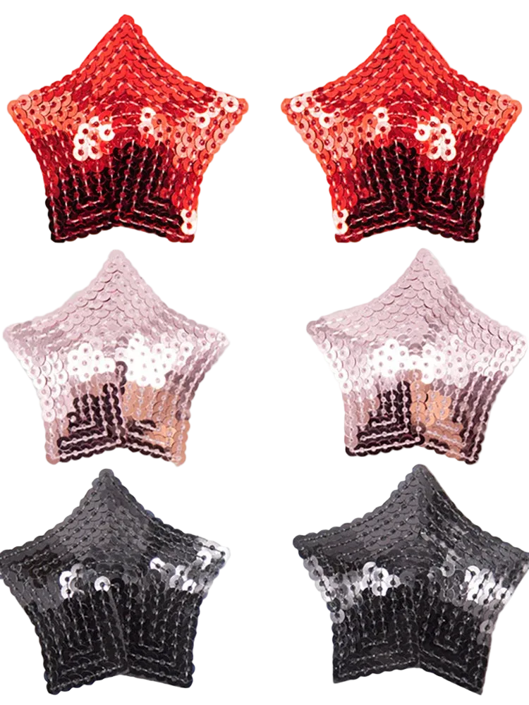 Six star-shaped sequin accessories arranged in a 3-by-2 grid on a white background, showing red-to-black ombre, blush-to-silver ombre, and black-to-silver ombre designs.