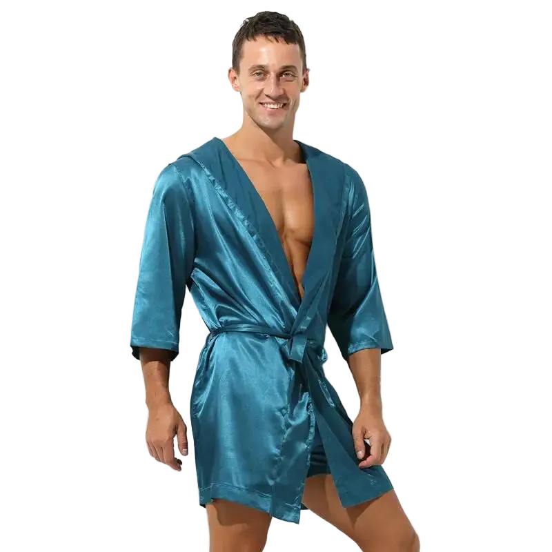 Man wearing a teal satin robe on a white background