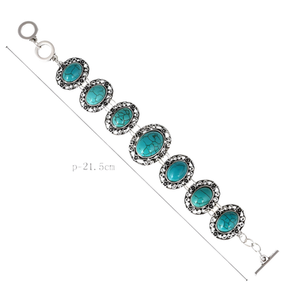 Bracelet with turquoise stones and silver accents on a white background