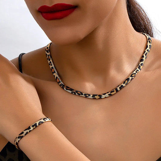 Leopard print necklace and bracelet on a person with red lipstick.