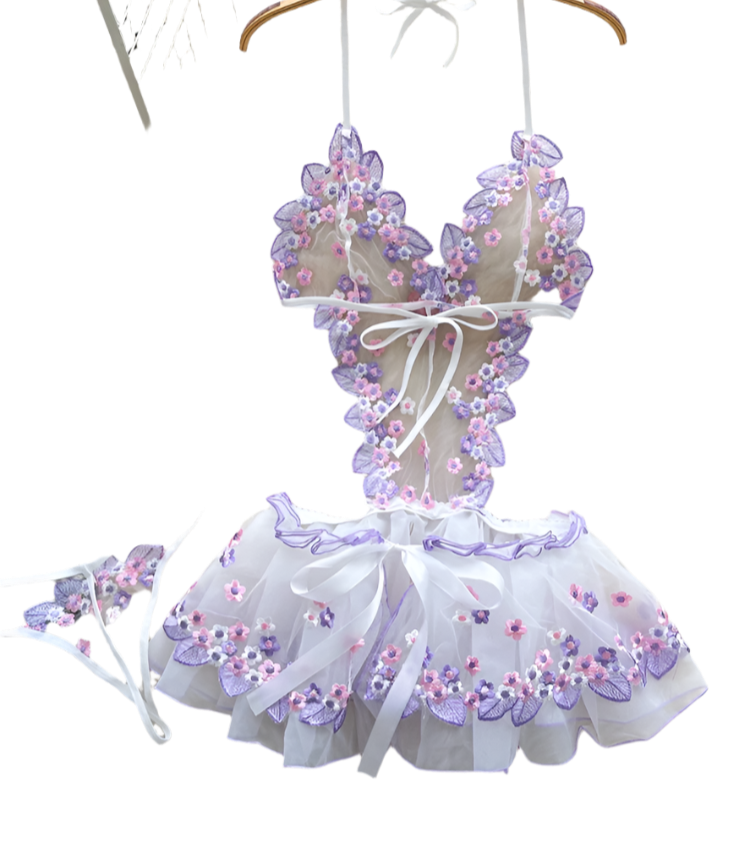Children's floral bikini set on a hanger with flowers and a basket in the background
