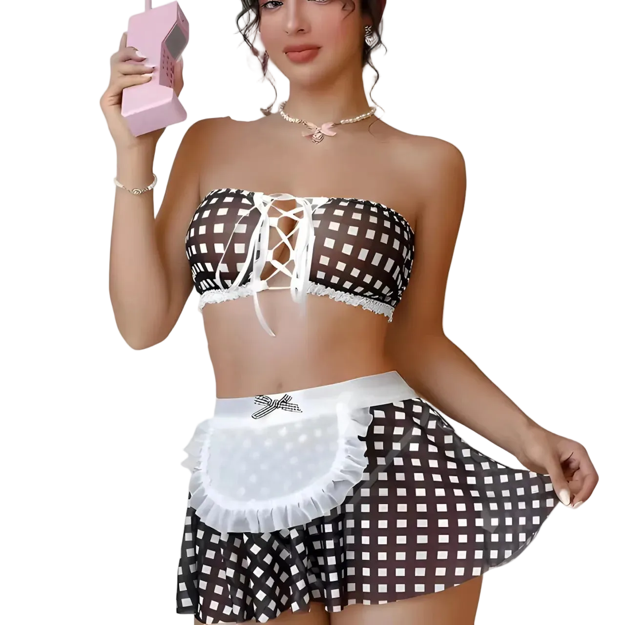 A woman models a two-piece lingerie-style outfit featuring a brown and white checkered bandeau top with lace-up front and ruffled trim, paired with a matching checkered mini skirt and white apron waist detail, against a plain white background.
