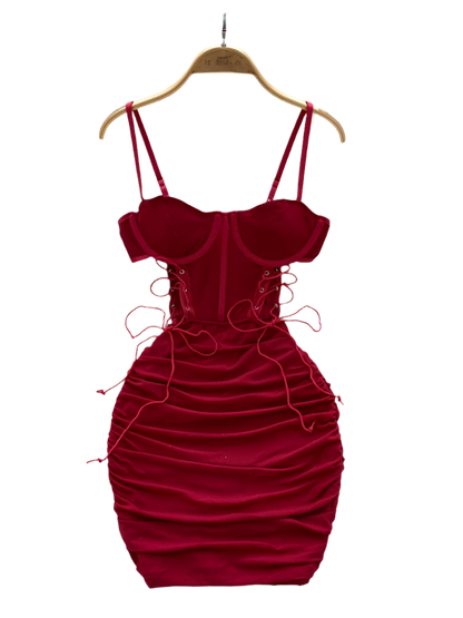 Red velvet dress on a hanger with a white floral background