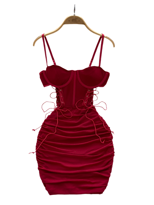 Red velvet dress on a hanger with a white floral background